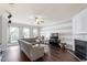 Comfortable living room with fireplace, hardwood floors, ceiling fan, and striped accent wall at 110 Great Ridge Ct, Morrisville, NC 27560