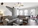 Open living room features a comfortable sectional sofa, ceiling fan, and ample natural light at 110 Great Ridge Ct, Morrisville, NC 27560