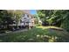 Beautiful backyard featuring a gazebo with hot tub, patio and a lush lawn surrounded by mature trees at 1106 Brittley Way, Apex, NC 27502