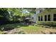 Serene backyard with lush lawn, mature trees, and charming gazebo with hot tub at 1106 Brittley Way, Apex, NC 27502