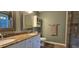 Bathroom with double sinks, granite countertop, and tile flooring at 1106 Brittley Way, Apex, NC 27502