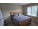 Cozy bedroom with a wooden frame bed and plenty of natural light at 1106 Brittley Way, Apex, NC 27502