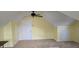 Cozy bonus room with neutral carpet, angled ceilings, and ceiling fan provides extra living space at 1106 Brittley Way, Apex, NC 27502