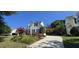 A nicely landscaped driveway leads to a charming home with green shutters at 1106 Brittley Way, Apex, NC 27502