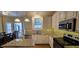 Kitchen featuring granite countertops, stainless appliances, tile backsplash, and ample storage at 1106 Brittley Way, Apex, NC 27502