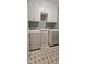 Convenient laundry room with washer, dryer, and cabinetry for storage at 1106 Brittley Way, Apex, NC 27502