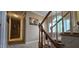 Inviting staircase with carpeted steps and a large window with natural light at 1106 Brittley Way, Apex, NC 27502