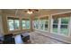 Bright sunroom with multiple windows providing natural light and views of the surrounding yard at 1106 Brittley Way, Apex, NC 27502
