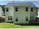 Rear exterior showcasing the siding and large windows providing ample natural light to the interior spaces at 1126 Woodlands Creek Way, Apex, NC 27502