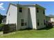 View of the rear exterior featuring light siding and showcasing windows that provide ample natural light at 1126 Woodlands Creek Way, Apex, NC 27502
