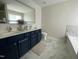 Beautiful bathroom with double sinks, framed mirror and modern cabinetry at 1126 Woodlands Creek Way, Apex, NC 27502