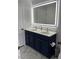 Bathroom with double sink vanity, modern lighting, and marble-like tile floors at 1126 Woodlands Creek Way, Apex, NC 27502