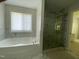 Bathroom with a soaking tub and glass-enclosed shower at 1126 Woodlands Creek Way, Apex, NC 27502