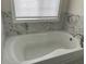Bathroom featuring a soaking tub with marble surround at 1126 Woodlands Creek Way, Apex, NC 27502