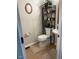 Compact bathroom featuring toilet with over-the-toilet shelving at 1126 Woodlands Creek Way, Apex, NC 27502