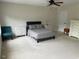 Spacious bedroom with neutral carpet, ceiling fan, and ample natural light at 1126 Woodlands Creek Way, Apex, NC 27502