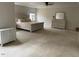 This neutral bedroom features a ceiling fan, sitting area, and carpeted floors at 1126 Woodlands Creek Way, Apex, NC 27502
