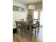 Comfortable dining area featuring a table set for six, neutral decor, and view of the backyard through glass doors at 1126 Woodlands Creek Way, Apex, NC 27502