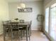 Charming dining area with seating for six, stylish decor, and a bright ambiance enhanced by natural light at 1126 Woodlands Creek Way, Apex, NC 27502