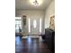 Inviting entryway with hardwood floors, white door with sidelights, and stylish decor at 1126 Woodlands Creek Way, Apex, NC 27502