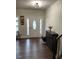Bright entryway with wood floors, stylish cabinet, and decorative front door at 1126 Woodlands Creek Way, Apex, NC 27502
