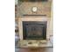 Close-up of the stone fireplace showcasing the stonework and mantle; an appealing focal point in the living space at 1126 Woodlands Creek Way, Apex, NC 27502