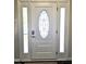 Stylish front door with decorative glass and sidelights for ample natural light at 1126 Woodlands Creek Way, Apex, NC 27502