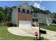 Two-story home with a two car garage, brick accents, covered porch, and a well-maintained driveway at 1126 Woodlands Creek Way, Apex, NC 27502