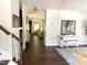 A view down the hall showcasing hardwood floors and a well-lit living space at 1126 Woodlands Creek Way, Apex, NC 27502