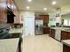 Spacious kitchen featuring granite counters, modern appliances, and seamless flow to the dining and living areas at 1126 Woodlands Creek Way, Apex, NC 27502