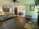 Cozy living room featuring dark wood floors, fireplace, and an open floor plan to kitchen and dining area at 1126 Woodlands Creek Way, Apex, NC 27502