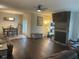 Open concept living and dining area with wood flooring and stone fireplace at 1126 Woodlands Creek Way, Apex, NC 27502
