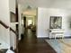 Open living room with hardwood floors and neutral decor at 1126 Woodlands Creek Way, Apex, NC 27502