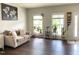 Inviting living room with dark wood floors, neutral walls, and natural light from the two windows at 1126 Woodlands Creek Way, Apex, NC 27502
