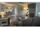 Open concept living and dining area with wood flooring and stone fireplace at 1126 Woodlands Creek Way, Apex, NC 27502