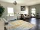 Open-concept living room featuring a modern chandelier and hardwood floors at 1126 Woodlands Creek Way, Apex, NC 27502