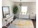 Bright living room featuring piano, modern white furniture, and stylish rug at 1126 Woodlands Creek Way, Apex, NC 27502