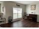 Cozy living room with window, Gathering decor and dark wood flooring at 1126 Woodlands Creek Way, Apex, NC 27502
