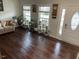 Living room with houseplants, lots of natural light and wood floors at 1126 Woodlands Creek Way, Apex, NC 27502
