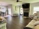Open-concept living area with fireplace, wood floors, and dining area at 1126 Woodlands Creek Way, Apex, NC 27502
