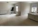 Bright main bedroom featuring a tray ceiling, carpet, and exercise equipment at 1126 Woodlands Creek Way, Apex, NC 27502