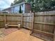 Fenced backyard with a brick patio and garden plot at 1136 Nottingham Cir, Cary, NC 27511