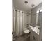 Cozy bathroom featuring a shower-tub combo and a modern single sink vanity at 1136 Nottingham Cir, Cary, NC 27511