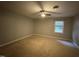 Bedroom with carpet floors, a ceiling fan, and a window providing natural light at 1136 Nottingham Cir, Cary, NC 27511