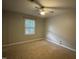 Bedroom featuring carpet floors, a ceiling fan, and a window providing natural light at 1136 Nottingham Cir, Cary, NC 27511