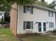 Two-story home with light siding, brick accents, green shutters, and a well-maintained lawn at 1136 Nottingham Cir, Cary, NC 27511