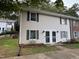 Charming two-story house featuring light siding, green shutters, and a well-manicured lawn at 1136 Nottingham Cir, Cary, NC 27511
