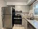 Modern kitchen featuring stainless steel appliances, granite countertops, and light cabinetry at 1136 Nottingham Cir, Cary, NC 27511