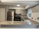 Open kitchen featuring granite countertops, stainless steel appliances, and tile backsplash at 1136 Nottingham Cir, Cary, NC 27511