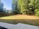 Large, fenced backyard featuring lush lawn and mature trees, offering privacy at 120 Glen Oaks Dr, Youngsville, NC 27596